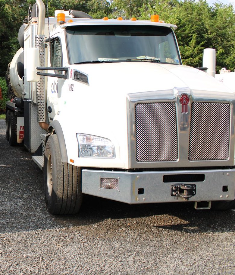 Kenworth T880 hydrovac head-on in ABI’s yard, chrome bumper and grille filling the frame