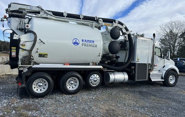 ABI hydrovac unit in profile, boom stowed, Kaiser Premier debris body over three axles